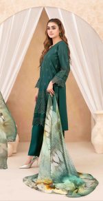 "Model wearing a bottle green embroidered ethnic suit with lace detailing, paired with a floral printed chiffon dupatta and silver heels.